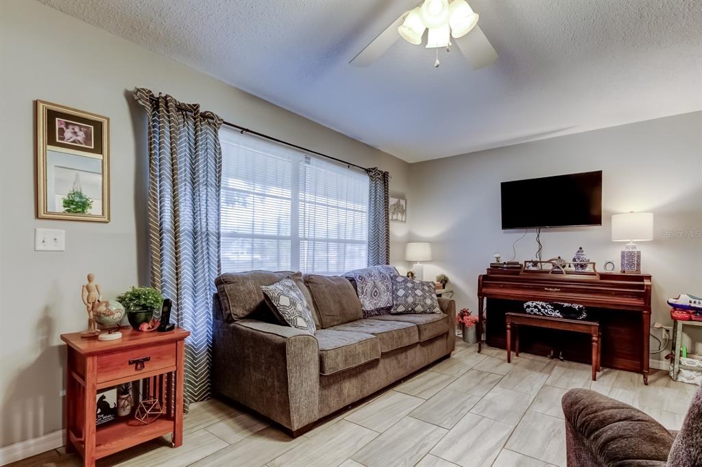 39748 Meadowood Loop Zephyrhills, FL 33542 - Photo 26 of 40 a living room with furniture and a flat screen tv