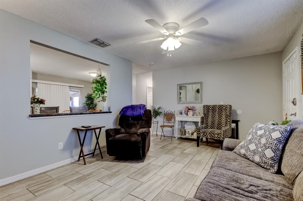 39748 Meadowood Loop Zephyrhills, FL 33542 - Photo 3 of 40 a living room with furniture and a chandelier