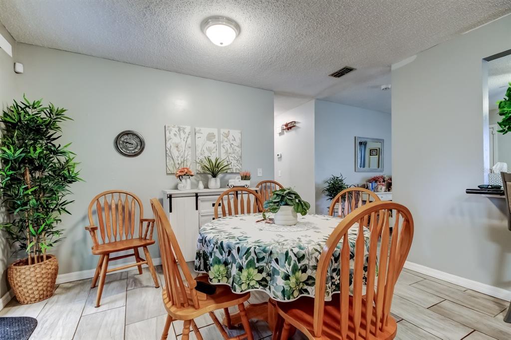 39748 Meadowood Loop Zephyrhills, FL 33542 - Photo 31 of 40 a view of a dining room with furniture and wooden floor