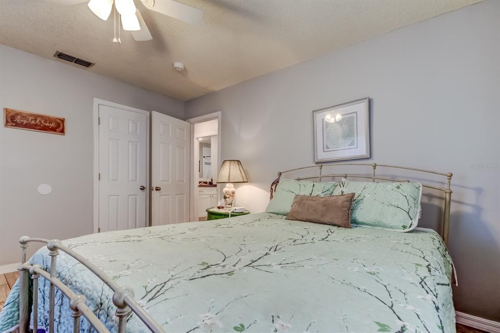 39748 Meadowood Loop Zephyrhills, FL 33542 - Photo 34 of 40 a bedroom with a bed and a chandelier