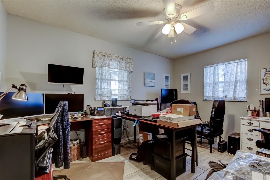 39748 Meadowood Loop Zephyrhills, FL 33542 - Photo 40 of 40 a view of a workspace with furniture and a chandelier