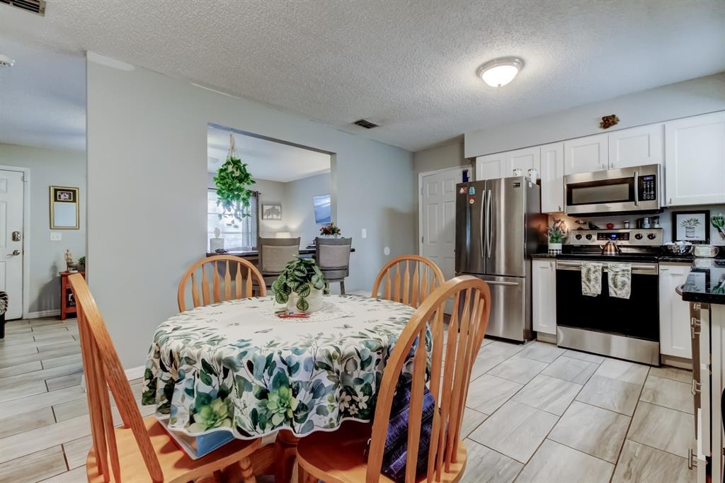 39748 Meadowood Loop Zephyrhills, FL 33542 - Photo 7 of 40 a view of a dining room with furniture