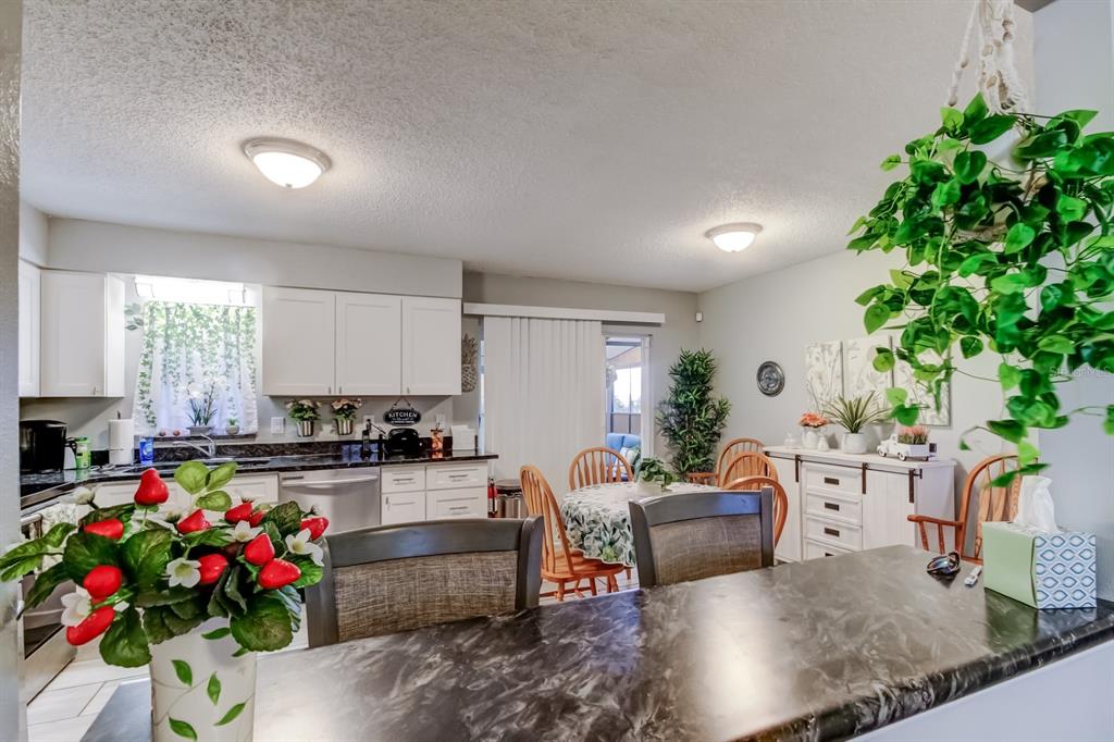 39748 Meadowood Loop Zephyrhills, FL 33542 - Photo 8 of 40 a living room with furniture and flowers