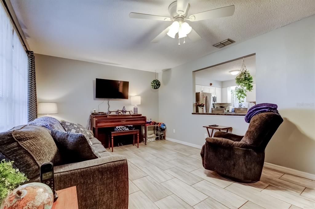 39748 Meadowood Loop Zephyrhills, FL 33542 - Photo 10 of 40 a living room with furniture and a flat screen tv