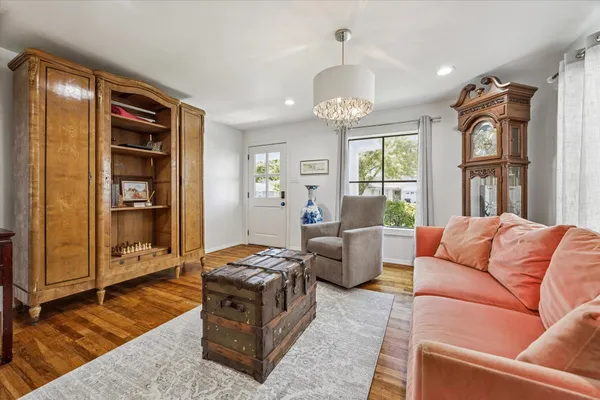 a living room with furniture fireplace and a window