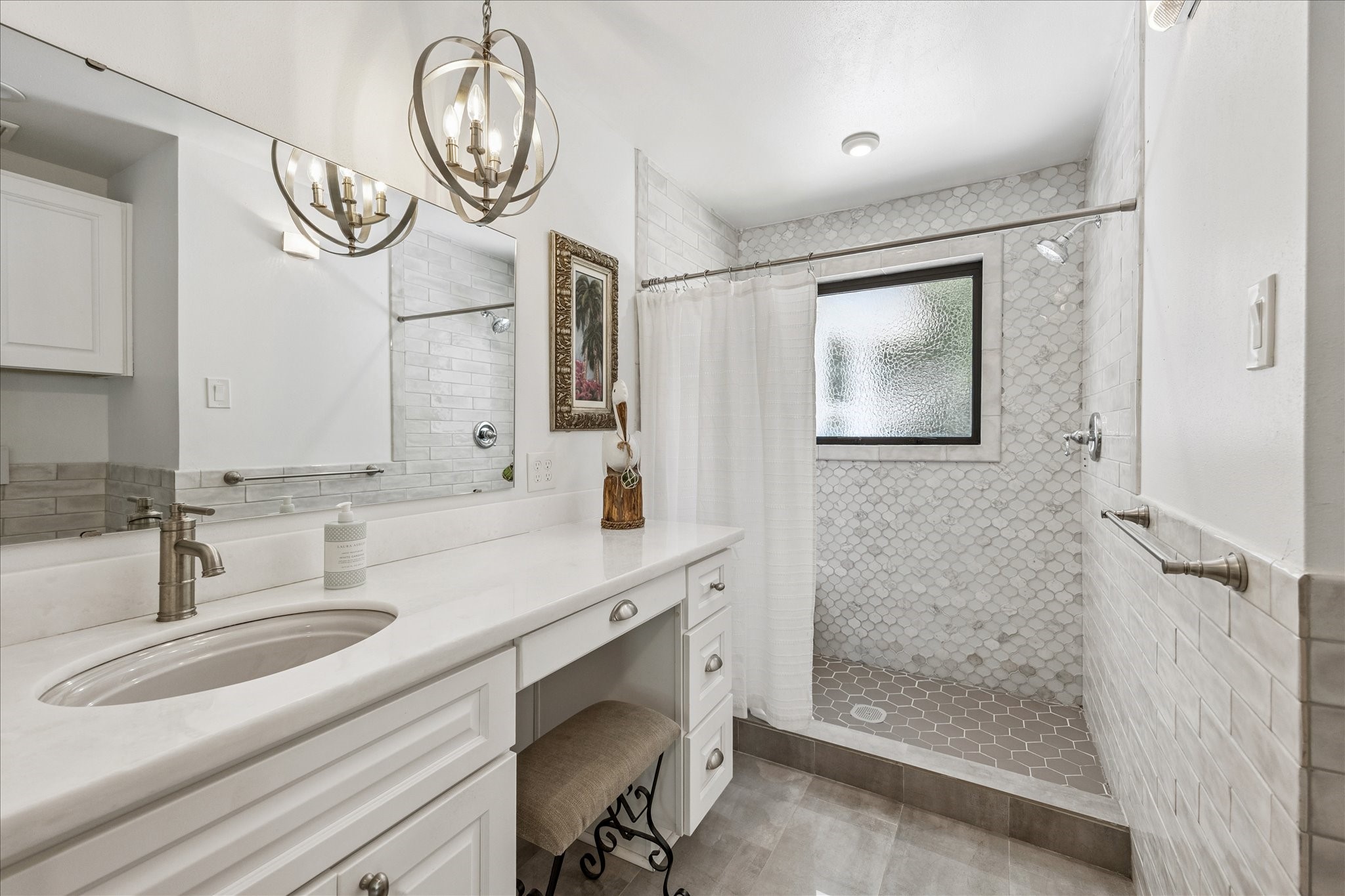 4710 Edison Street Houston, TX 77009 - Photo 7 of 18 a bathroom with a sink a mirror and a shower