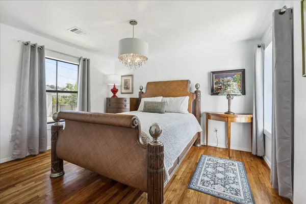 a bedroom with a bed and wooden floor