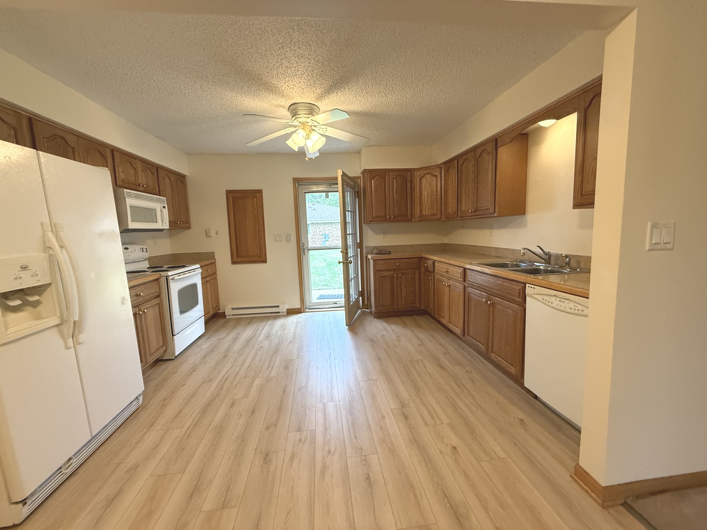 532 West Street, Unit 4 Lockport, IL 60441 - Photo 2 of 14 a kitchen with stainless steel appliances granite countertop a refrigerator a sink dishwasher a stove and white countertops with wooden floor