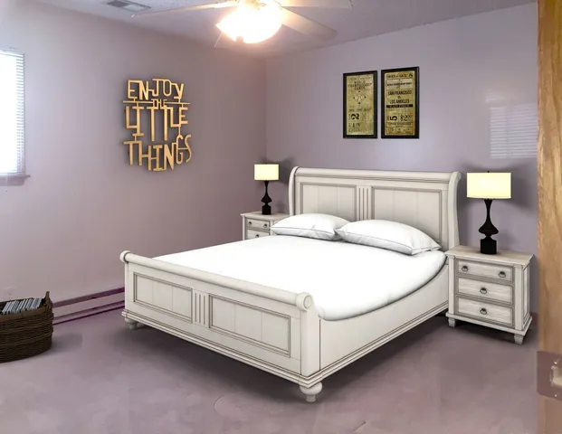 a bedroom with a bed and a lamp on dresser