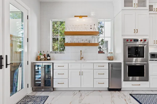 a large kitchen with stainless steel appliances granite countertop a lot of counter space and wooden floors