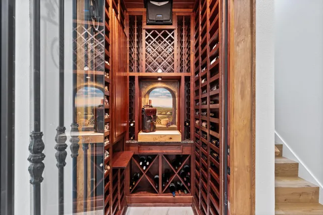 a spacious bedroom with a bed and a flat screen television