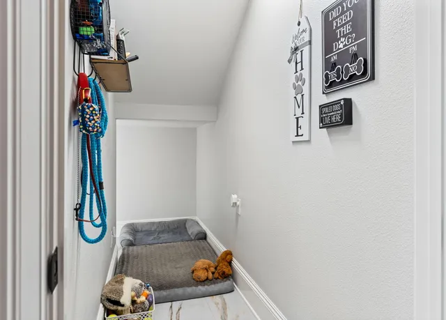 a room with furniture a large window and white walls