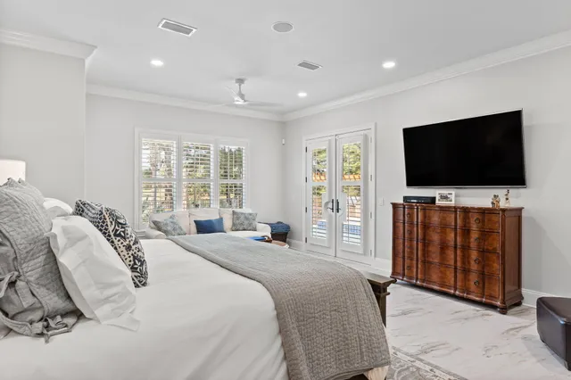 a kitchen with stainless steel appliances a sink a stove and white cabinets with wooden floor