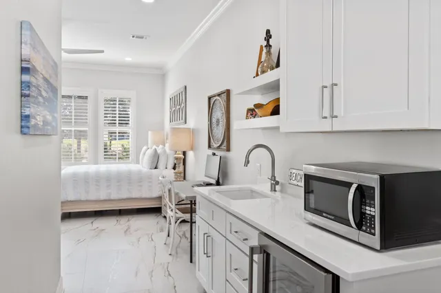 a view of a house with pool and chairs