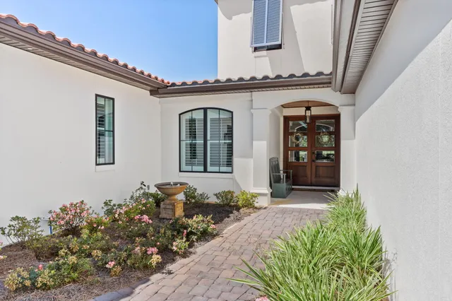 a living room with fireplace furniture and a large window