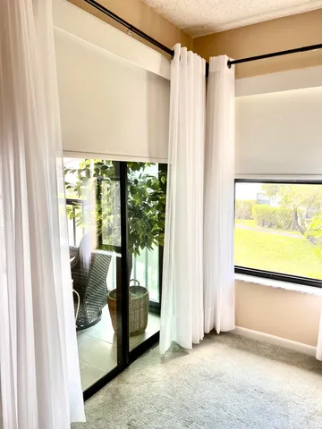 a view of a room that has a bed and a window