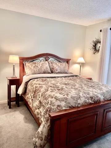 a bedroom with a bed and a lamp