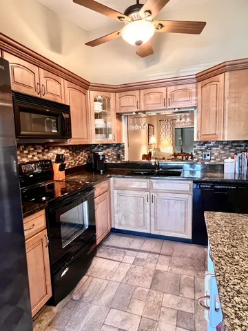 a kitchen with a stove a sink and a microwave