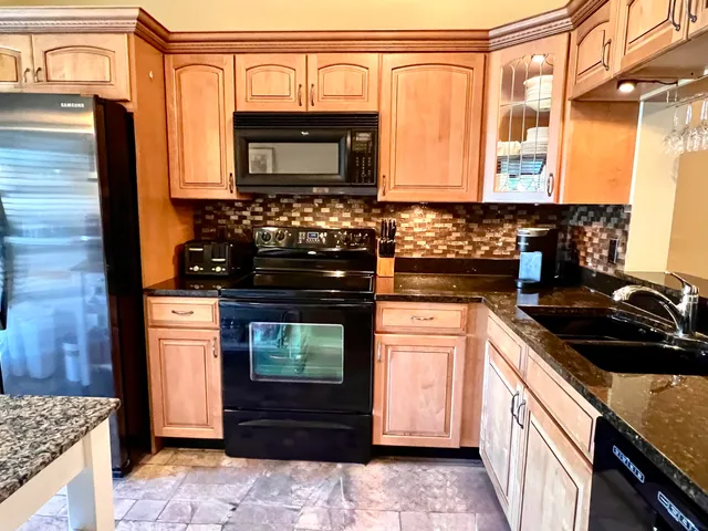a kitchen with stainless steel appliances granite countertop a stove and a microwave