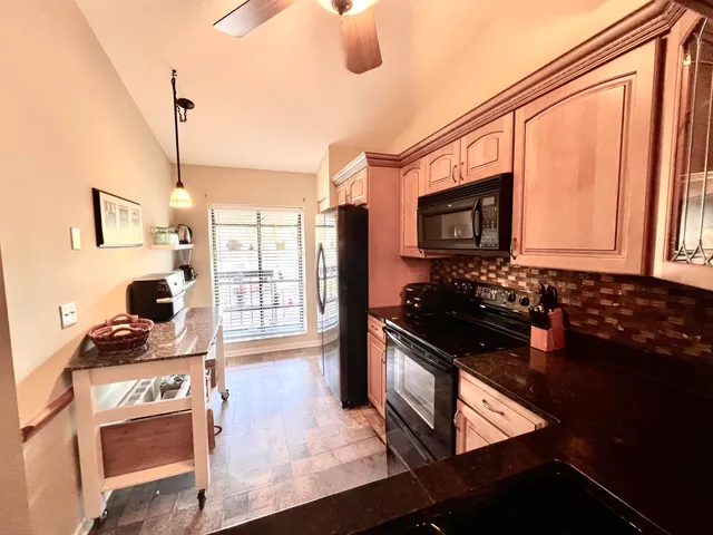 a kitchen with a stove a sink and a microwave