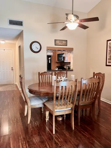 a view of a dining room with furniture and wooden floor