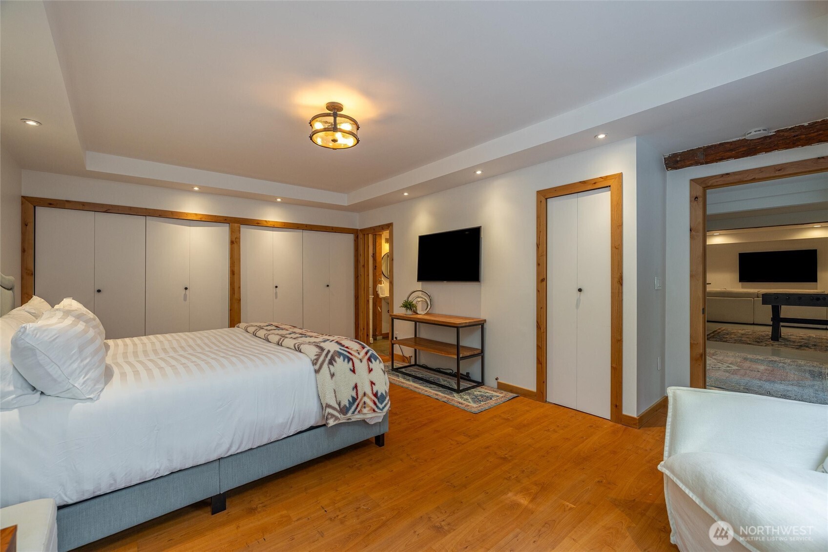 7577 Canyon View Drive Deming, WA 98244 - Photo 30 of 40 a bedroom with a bed and a flat tv screen on dresser