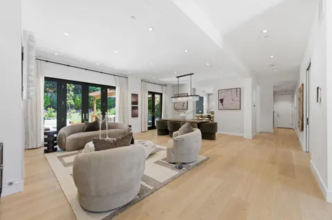 a living room with furniture fireplace and a large window