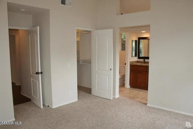 a view of a kitchen with an entryway and wooden floor