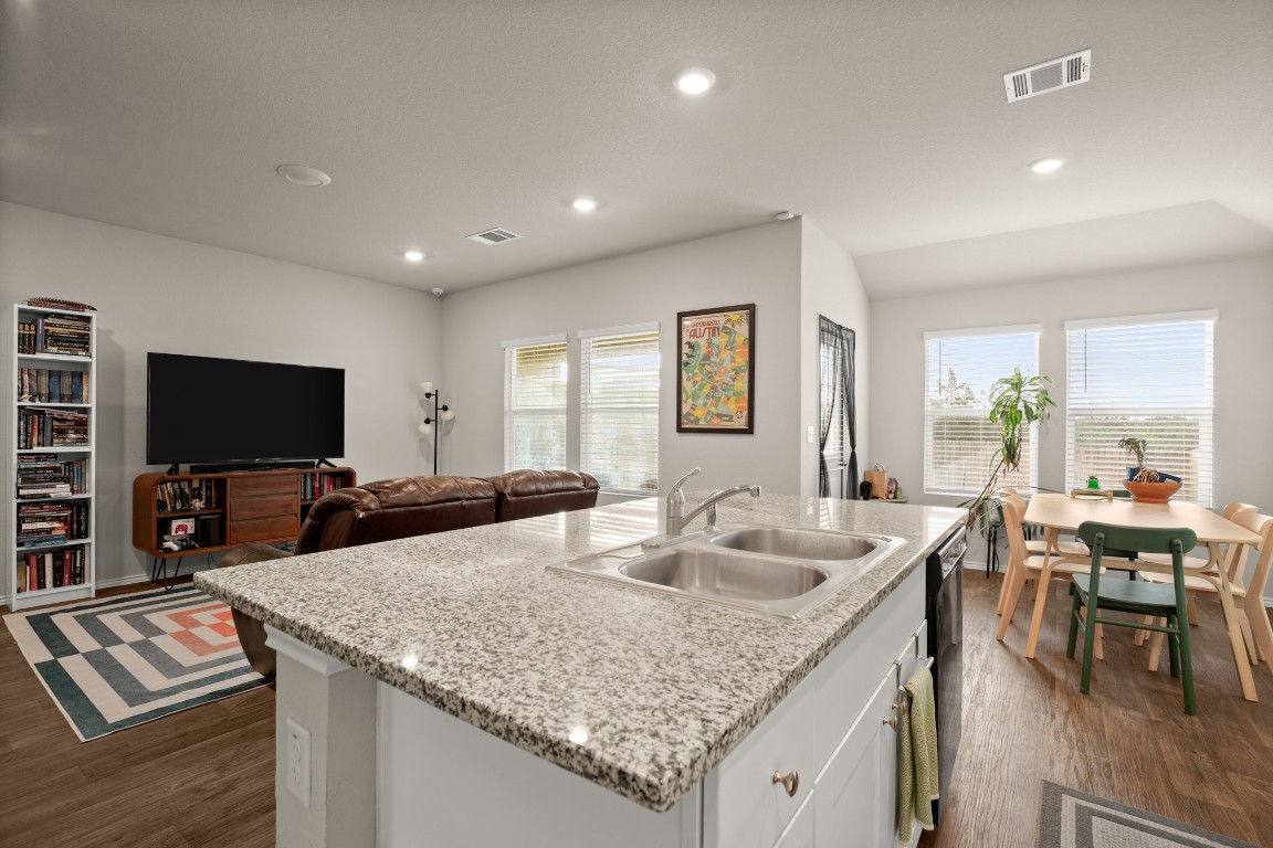 5817 Brocade Drive Austin, TX 78724 - Photo 1 of 1 a kitchen with granite countertop a sink and a refrigerator