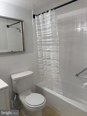 a bathroom with a bathtub and a toilet