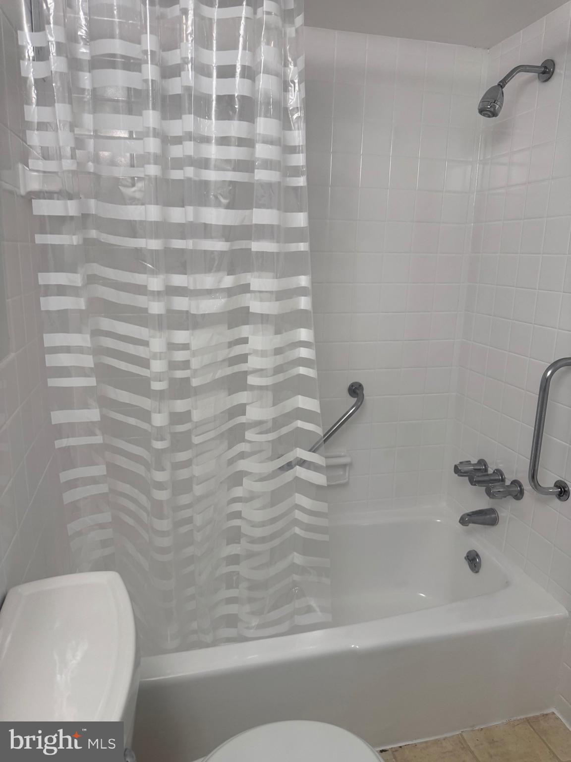 1111 University Boulevard West, Unit 501A Silver Spring, MD 20902 - Photo 5 of 11 a bathroom with a bathtub and a toilet