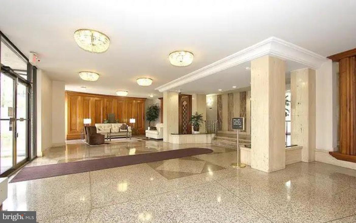 1111 University Boulevard West, Unit 501A Silver Spring, MD 20902 - Photo 8 of 11 a living room with furniture and a large window