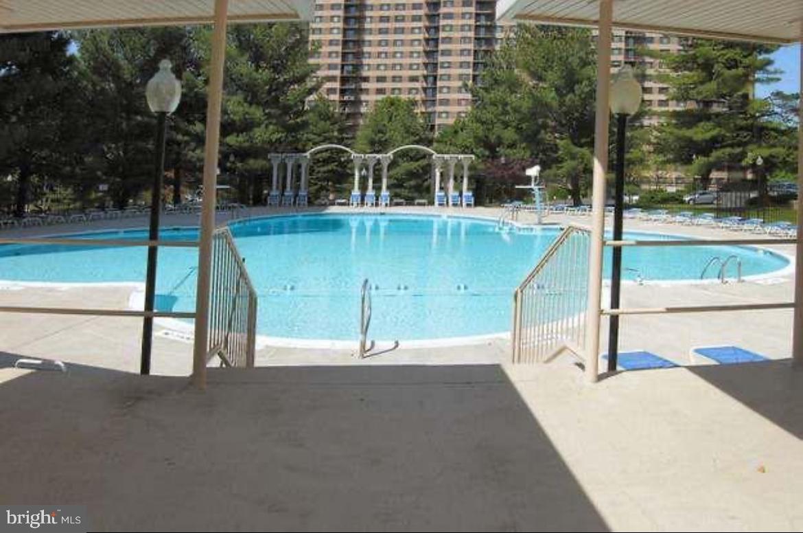 1111 University Boulevard West, Unit 501A Silver Spring, MD 20902 - Photo 9 of 11 a view of a swimming pool with a patio
