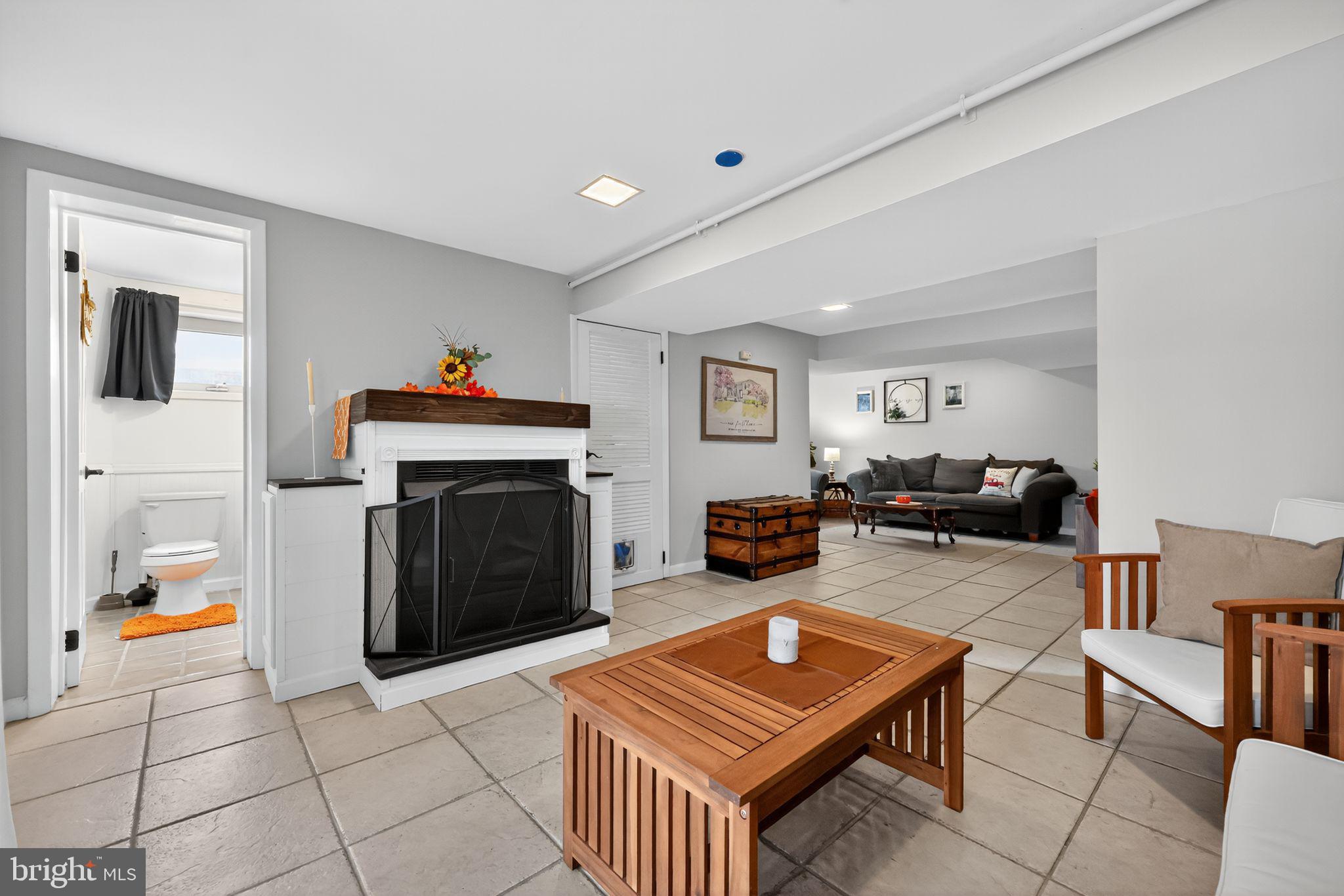 33 Beach Avenue Pennsville, NJ 08070 - Photo 13 of 32 a living room with furniture a flat screen tv and a fireplace