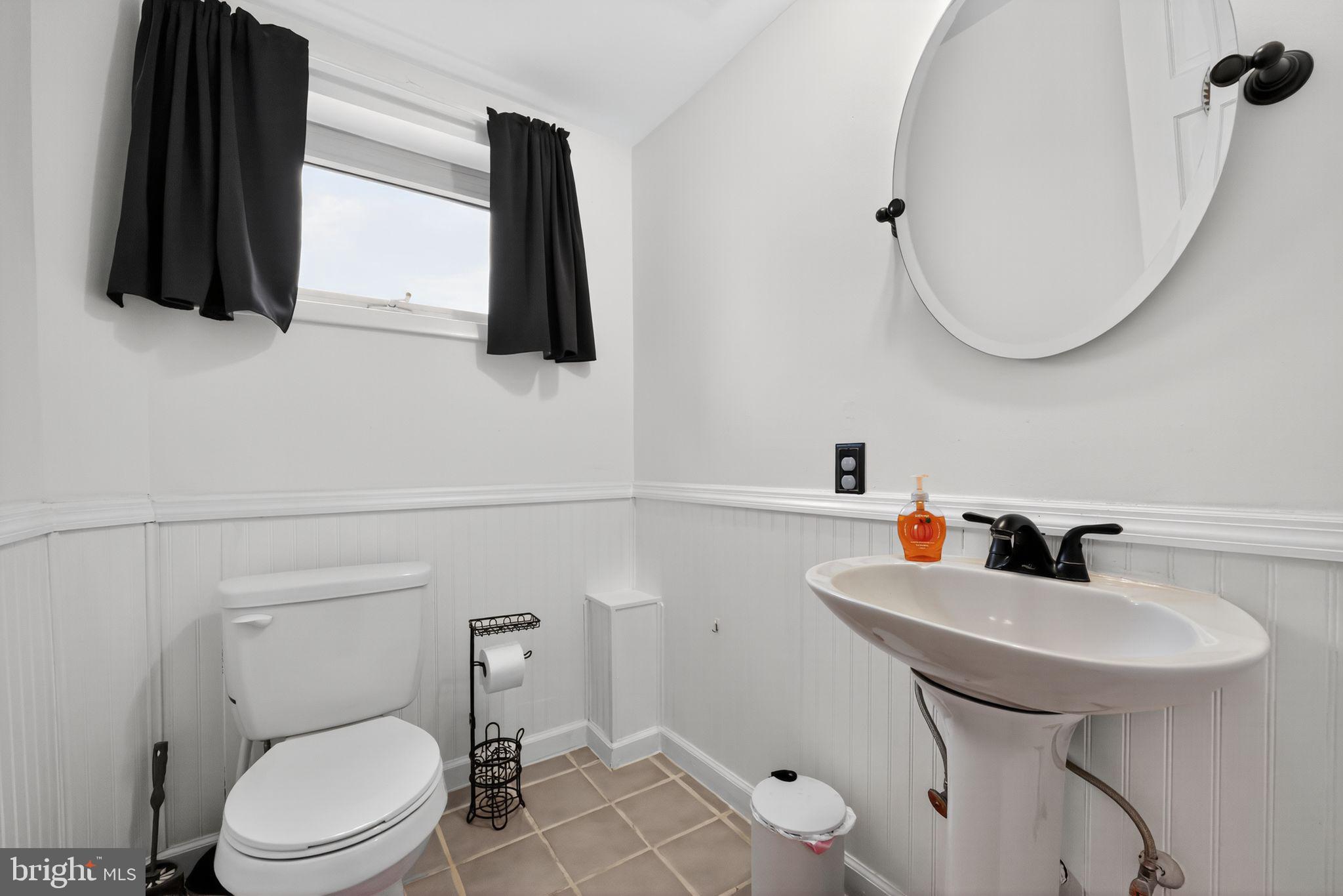 33 Beach Avenue Pennsville, NJ 08070 - Photo 15 of 32 a bathroom with a sink a toilet and mirror