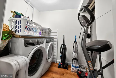 a living room with furniture and a dining table