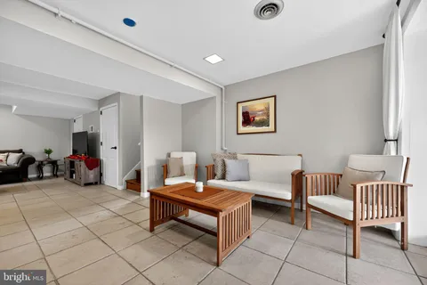 a dining room with furniture and front door