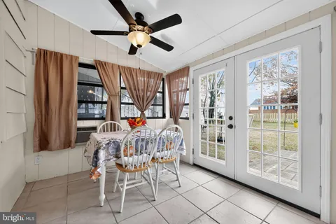 a living room with furniture a flat screen tv and a large window