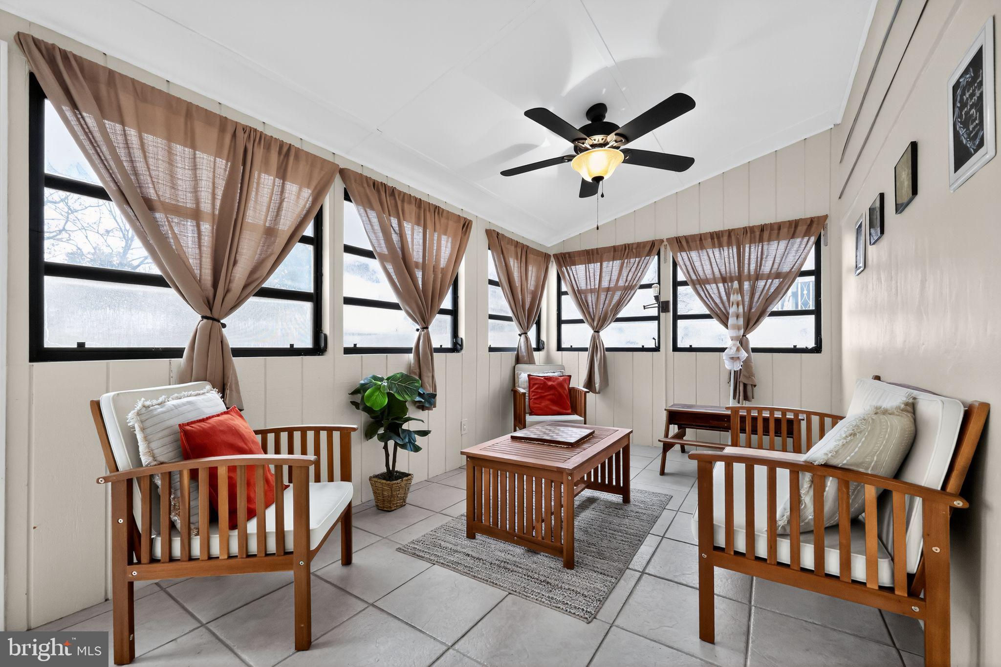 33 Beach Avenue Pennsville, NJ 08070 - Photo 19 of 32 a living room with furniture a flat screen tv and a large window