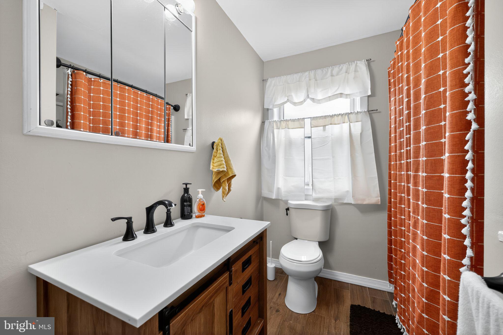 33 Beach Avenue Pennsville, NJ 08070 - Photo 26 of 32 a bathroom with a sink a toilet and a mirror