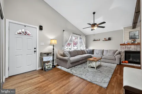a living room with furniture and a lamp