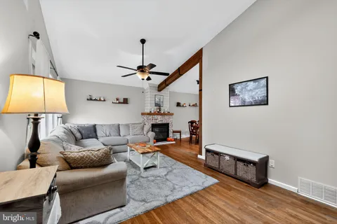 a dining room with furniture and wooden floor