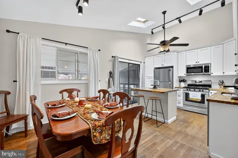 a kitchen with a stove a refrigerator and a dining table
