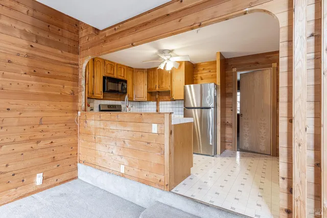 a view of kitchen with refrigerator cabinets and outdoor space