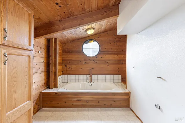 a bathroom with a tub and shower