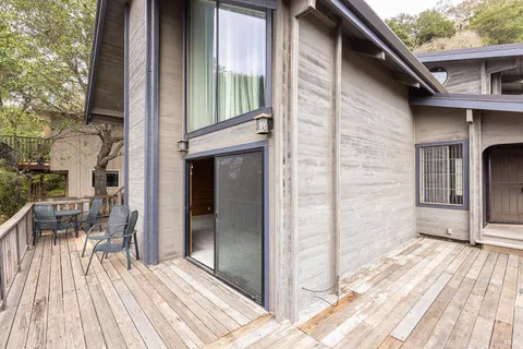 a view of balcony with wooden floor and fence