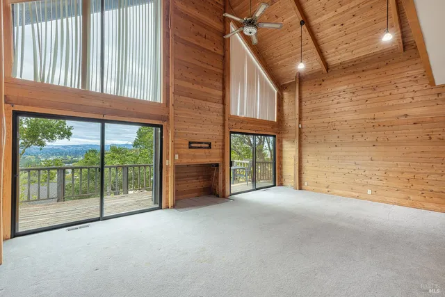 a view of an empty room with floor to ceiling windows
