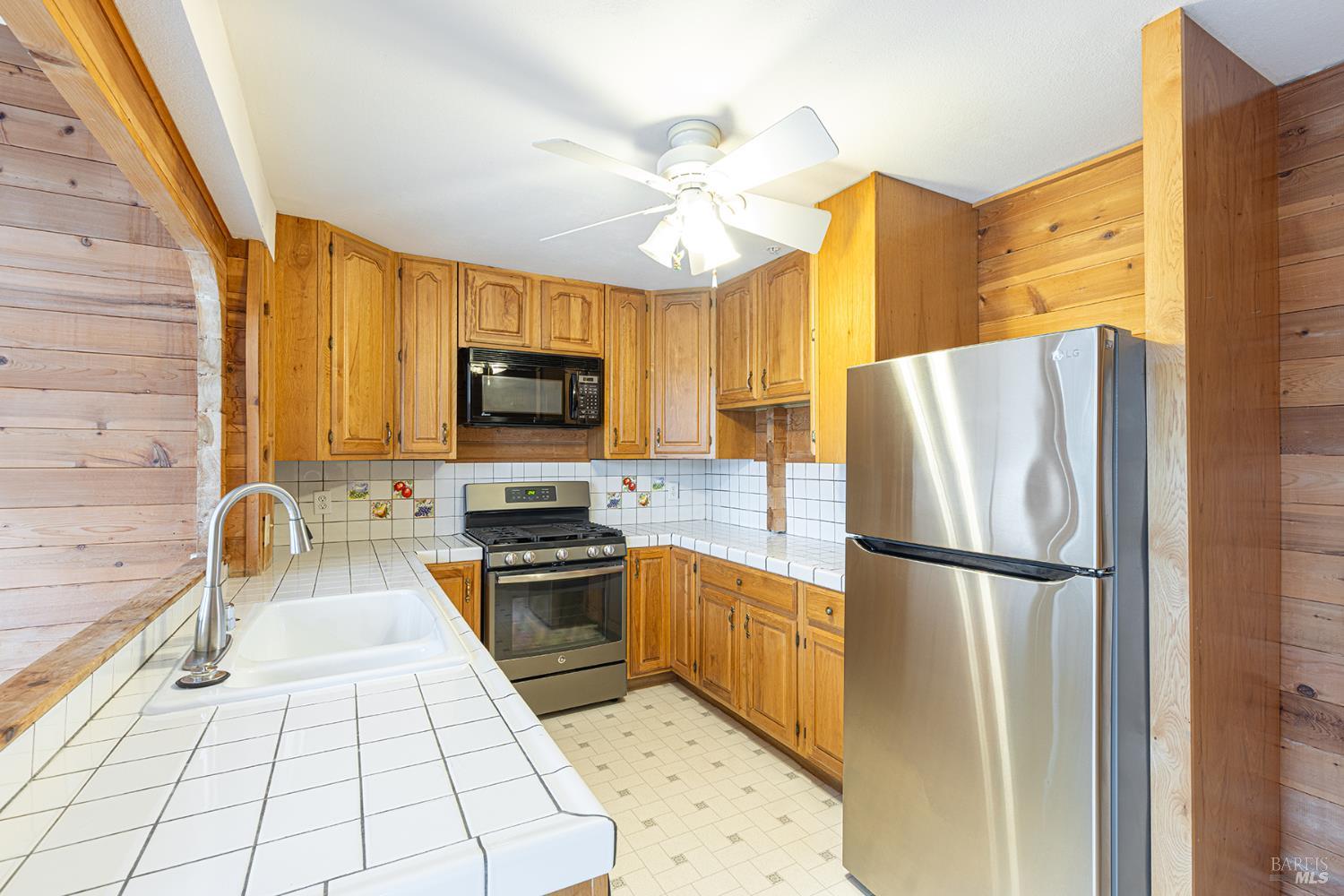 1450 Sproul Avenue Napa, CA 94559 - Photo 9 of 43 a kitchen with a refrigerator a stove top oven a sink and dishwasher