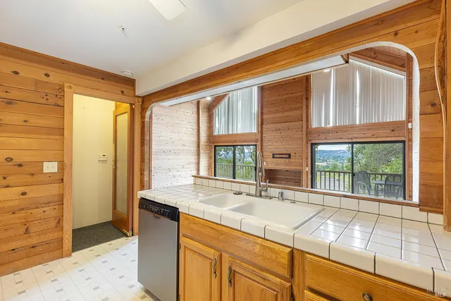 a bathroom with a granite countertop sink and a large mirror