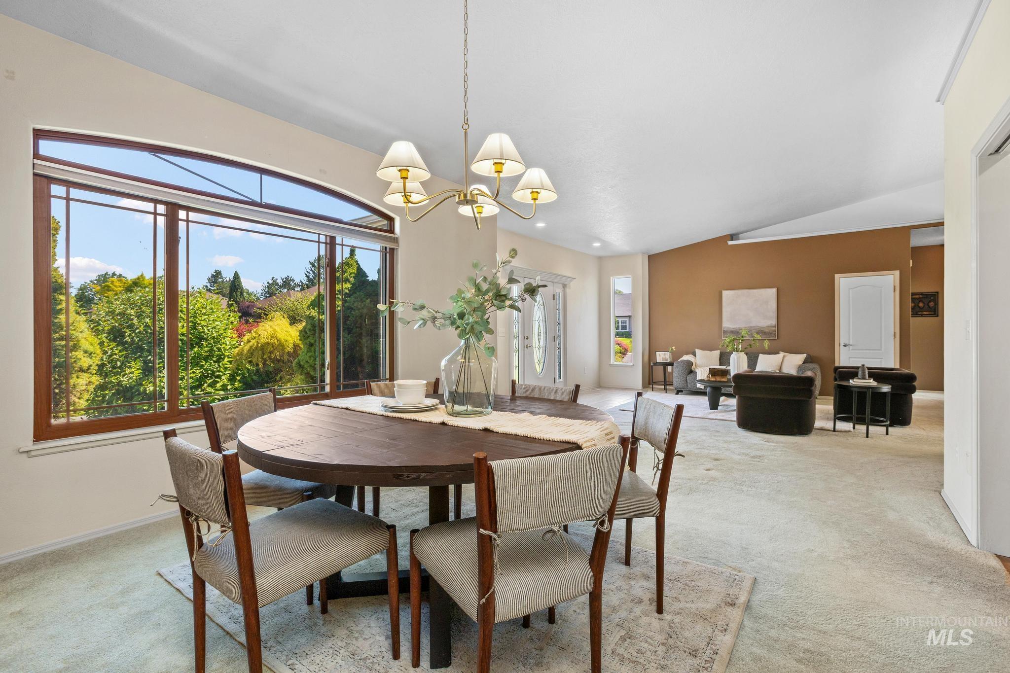 15181 Drury Way Caldwell, ID 83607 - Photo 12 of 49 Dining area featuring a large bay window with wood-frame detailing and an arched transom